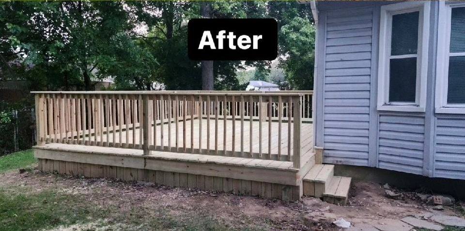 The same corner of the same house with a brand-new pressure-treated pine deck in place, a full spindle railing along two sides and a set of steps down to the yard.